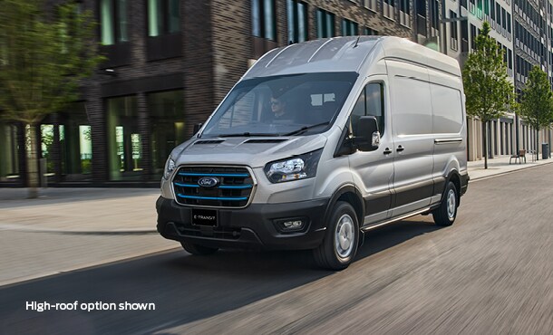 Silver Ford E-Transit driving on the road in the city