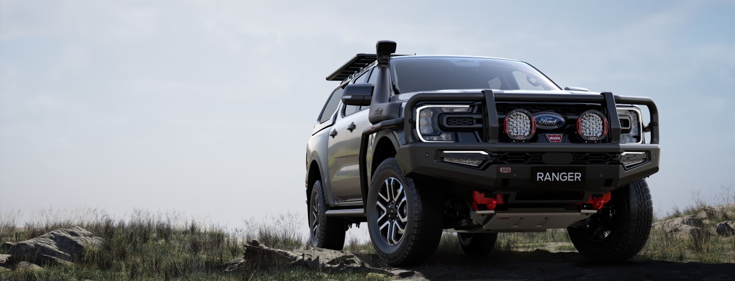 Ford Ranger with ARB accessories driving on off-road terrain uphill