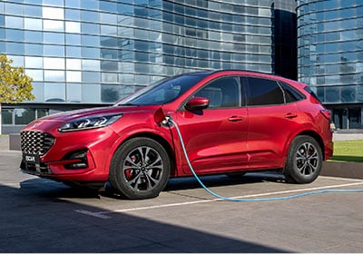 Red 2020 Ford Escape PHEV charging in car park