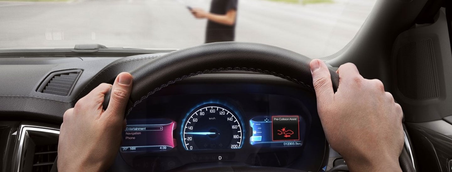 Ford Escape using AEB in front of pedestrian with hands on steering wheel