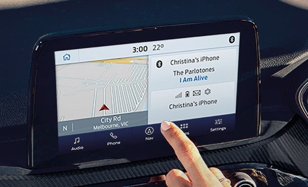 Woman using Ford SYNC3 infotainment system